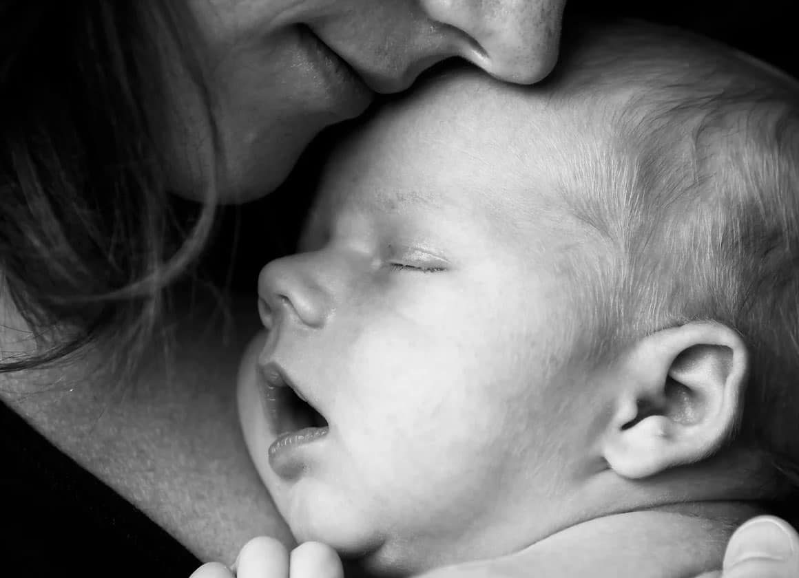 Mother caressing sleeping baby